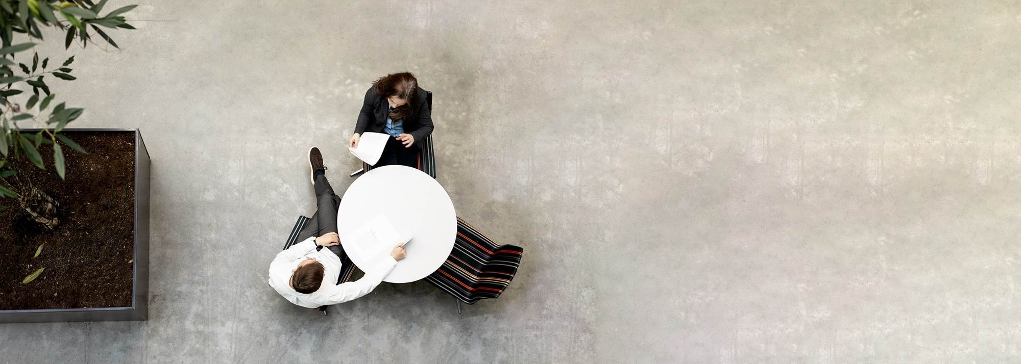 Two people are sitting at a table in atrium