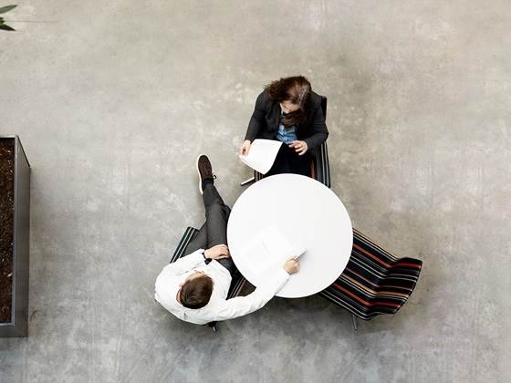 Two people are sitting at a table in atrium